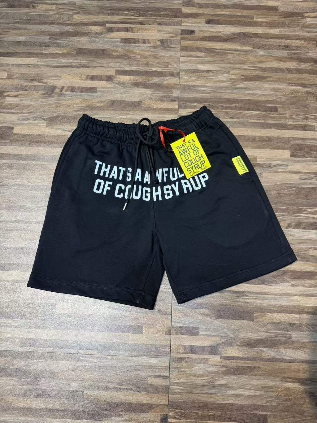 THAT'S A AWFUL LOT OF COUGH SYRUP Black Graphic Shorts ¡ª front