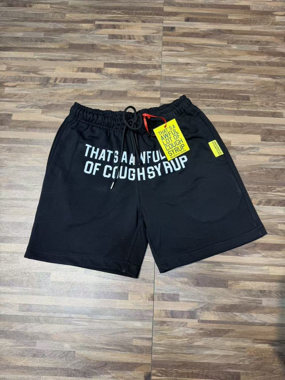 THAT'S A AWFUL LOT OF COUGH SYRUP Black Graphic Shorts ¡ª front