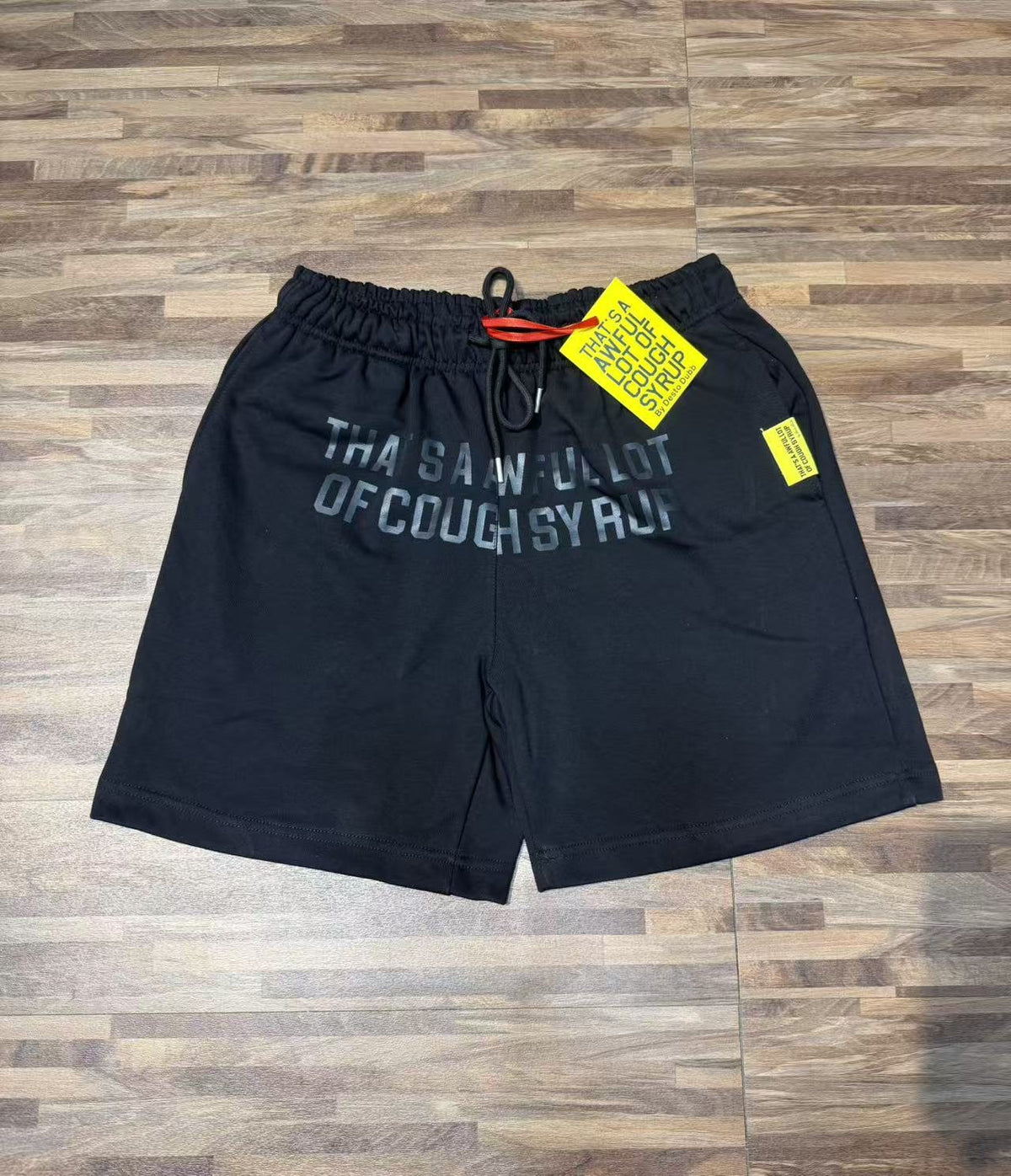 THAT'S A AWFUL LOT OF COUGH SYRUP Black Graphic Shorts ¡ª front